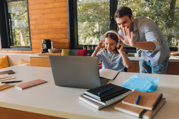 istock Little boy and his father using technology and having video call 1299664375