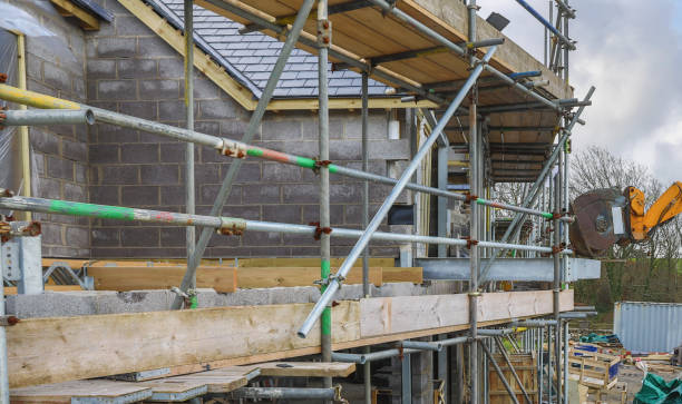 istock Scaffolding erected for a residential build with machine assisting 1299664497