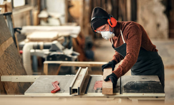 istock Woodworker cutting wood in workshop 1299664622