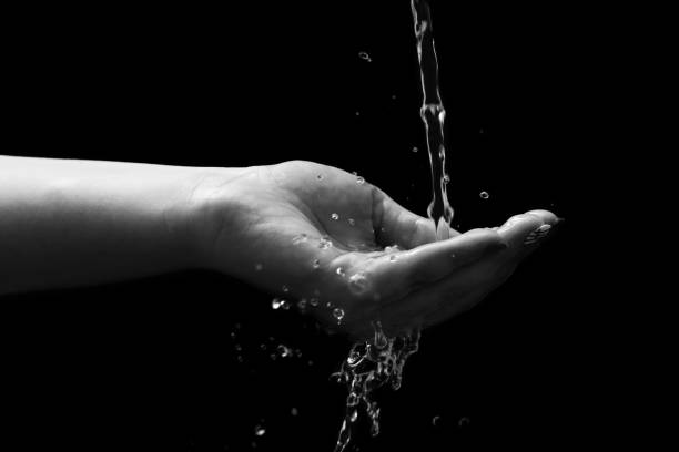 istock Woman hand with water splash 1299665480