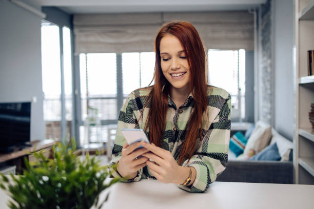 istock Cute redhead girl surfing the net at home 1299665911