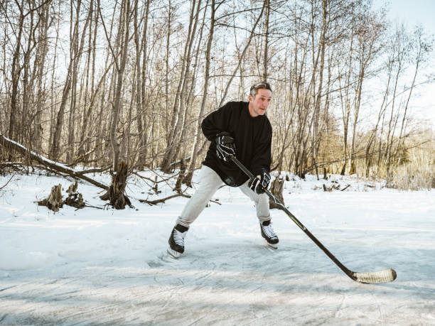 istock Mature man playing hockey outdoors 1299669754