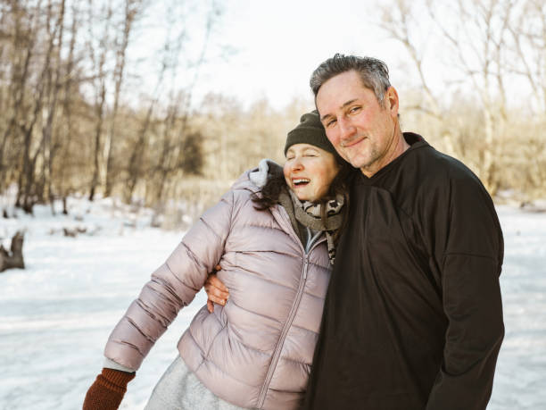 istock Mature couple posing for photo on skating rink 1299669801