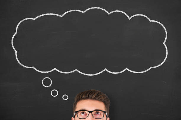istock Business man standing next to thought bubble drawn on chalkboard 1299669904