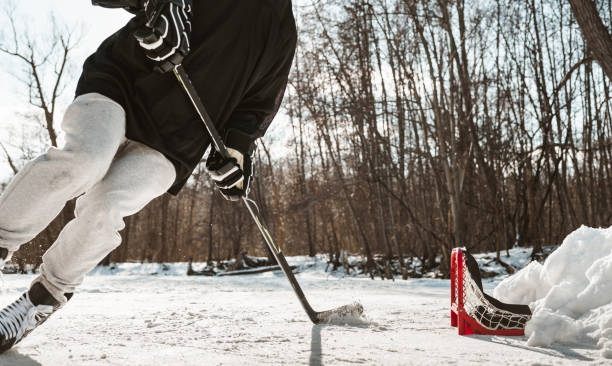istock Mature man playing hockey outdoors 1299671709