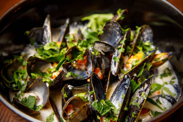 istock Traditional belgian mussels in cheese sauce, close-up 1299671731