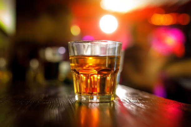 istock Glass of scotch whiskey on the bar background. 1299671843