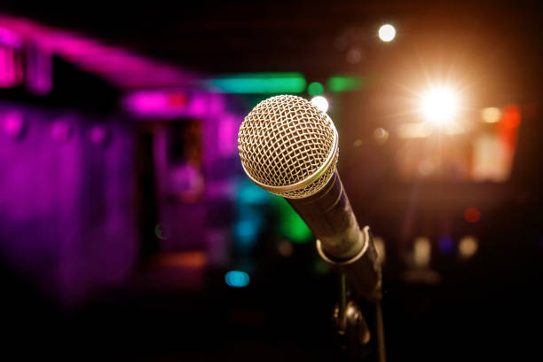 istock Microphone on stage against a background of auditorium 1299671865