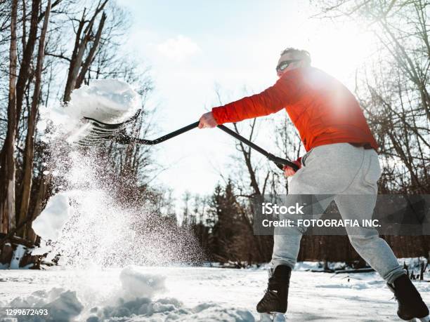 Mature Man Clearing Snow Stock Photo - Download Image Now - Snow, Shovel, Snow Shovel