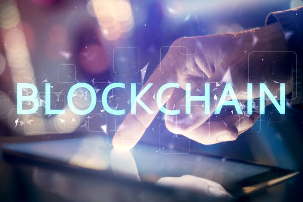 istock Double exposure of man's hands holding and using a phone and crypto currency blockchain theme drawing. 1299672552