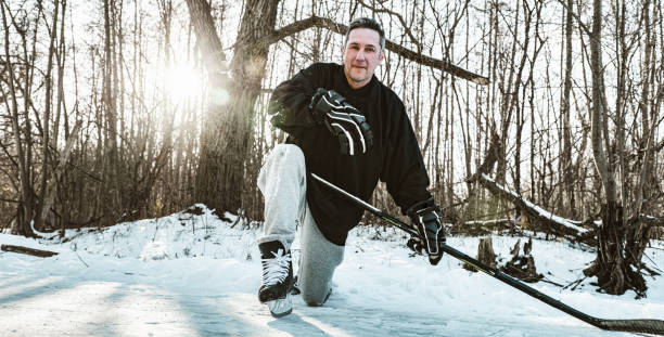 istock Mature man playing hockey outdoors 1299672681