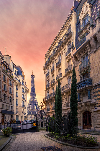 Paris, France - January 20, 2021: A back alley in Paris showcasing the architecture of the buildings with the Eiffel Tower in the background