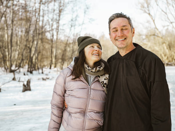 istock Mature couple posing for photo on skating rink 1299673447