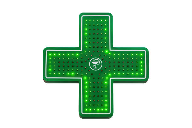 istock Pharmacy emblem. Green cross with a bowl and a snake 1299673539