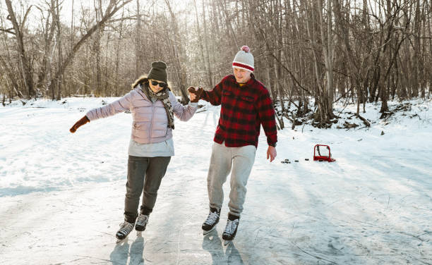 istock Mature couple ice skating outdoors 1299673546