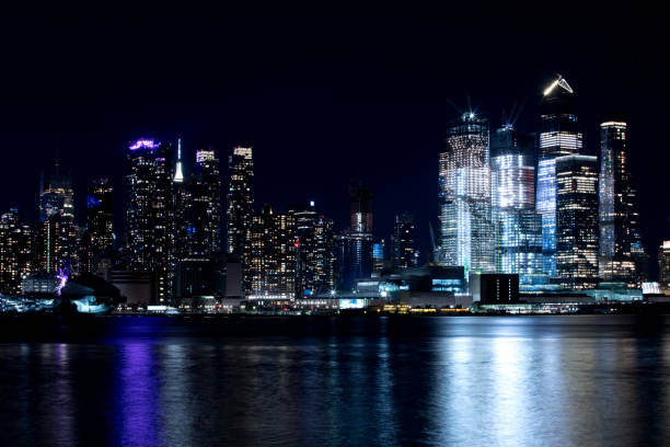 View is of various skyscrapers, apartments and office building in Manhattan shot from New Jersey directly across the Hudson River.