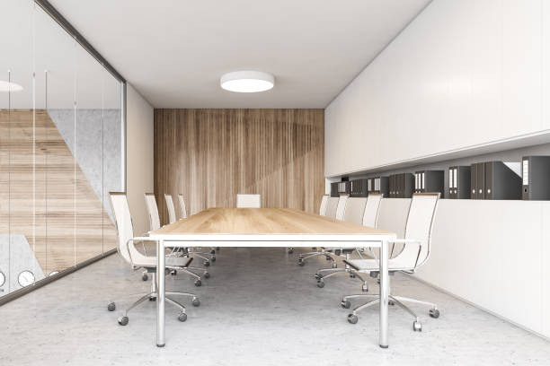 istock Conference room with white chairs and wooden table, glass doors white walls 1299674804