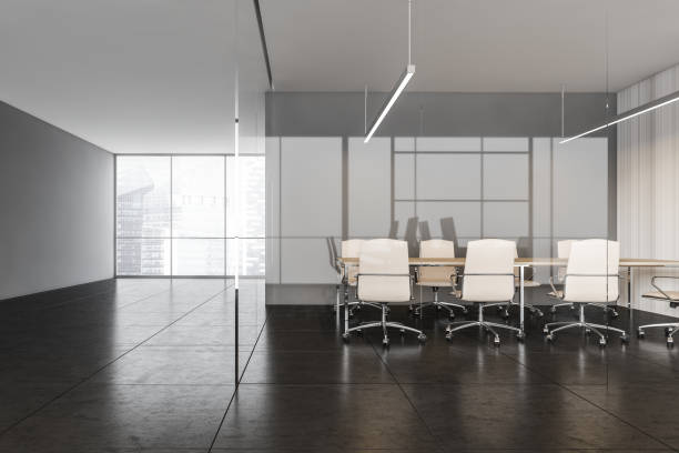 istock Black and white conference room with leather armchairs with window 1299674915