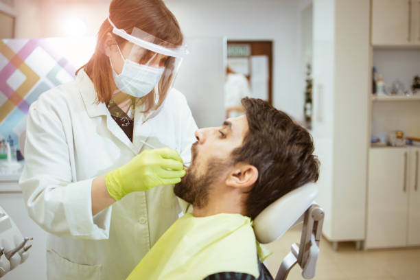 istock Young man visiting a dental office 1299675438