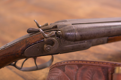 Antique 12 gauge double barrel shot gun.  On display for sale.