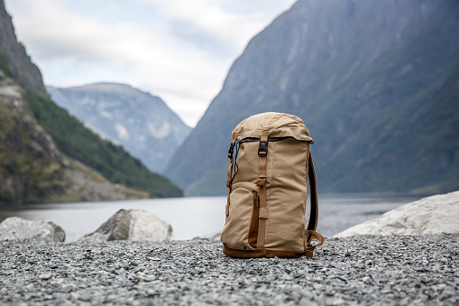 Tourists backpack. Norvegian Fjords on the background