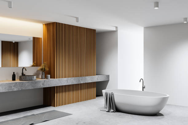 istock White and concrete bathroom corner with tub and double sink 1299676488