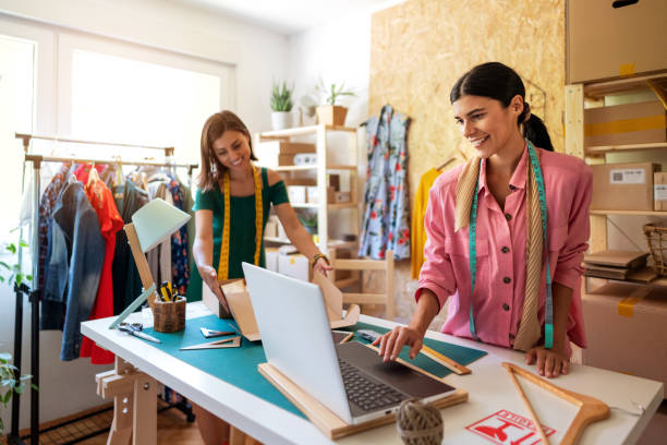 istock Two cheerful young small business owners preparing new orders for online customers 1299679274