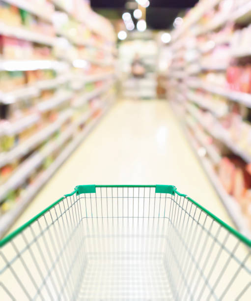 istock empty green shopping cart in supermarket aisle 1299679631