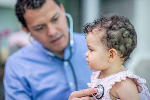 istock Paediatrician with a young baby patient 1299679674