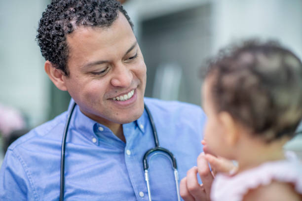 istock Smiling male doctor with young patient 1299679678