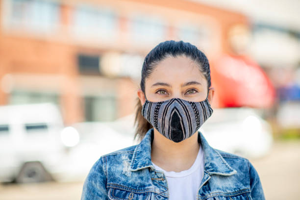 istock Smiling woman behind a face mask 1299680871