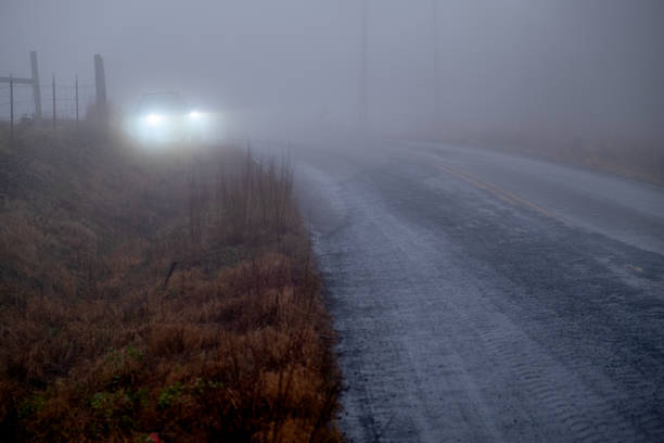 istock Car Parked on Foggy Rural Highway 1299683718