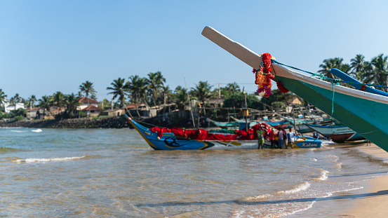 Many traditional fishing boats in the harbor at the local fish market in Galle, Sri Lanka