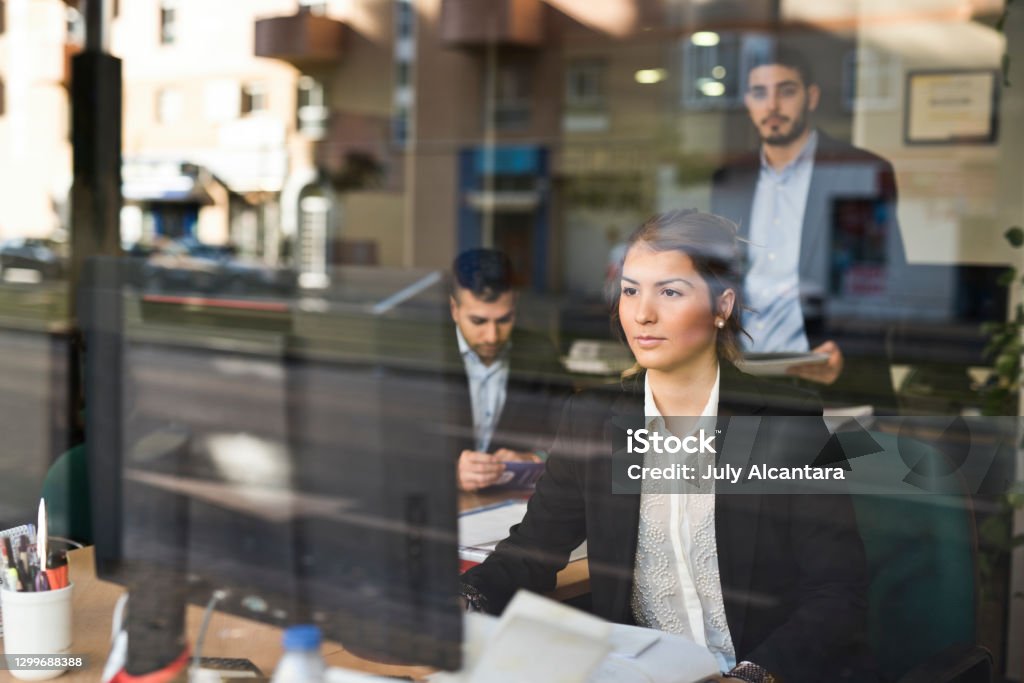 People working in an office seen through the window in a business company Bank - Financial Building Stock Photo