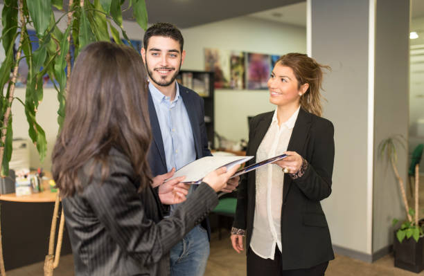 istock workers in the office exchange ideas and work in a positive environment 1299688399