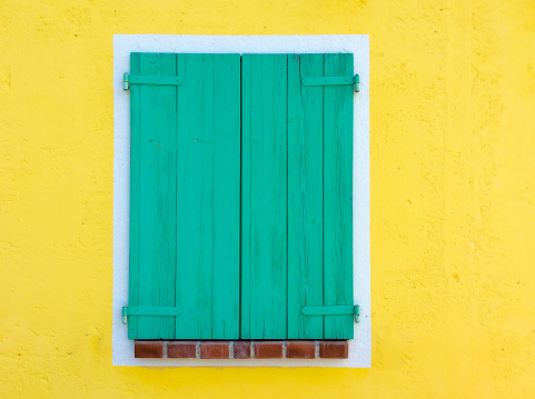 Bright Yellow Wall with Green Shutter