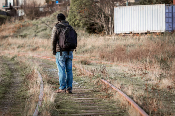 istock Man Standing On The Railroad Tracks 1299690856