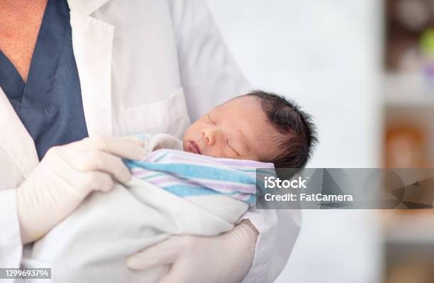 Doctor Holding Newborn Baby Stock Photo - Download Image Now - Newborn, Baby - Human Age, Hospital