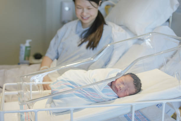 istock Mother looking at newborn baby 1299693801