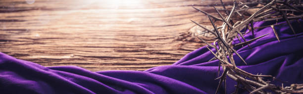 Crown Of Thorns And Purple Robe Crown Of Thorns And Purple Robe On Wooden Floor With Sunlight - Crucifixion Of Jesus Christ holy week photos stock pictures, royalty-free photos & images