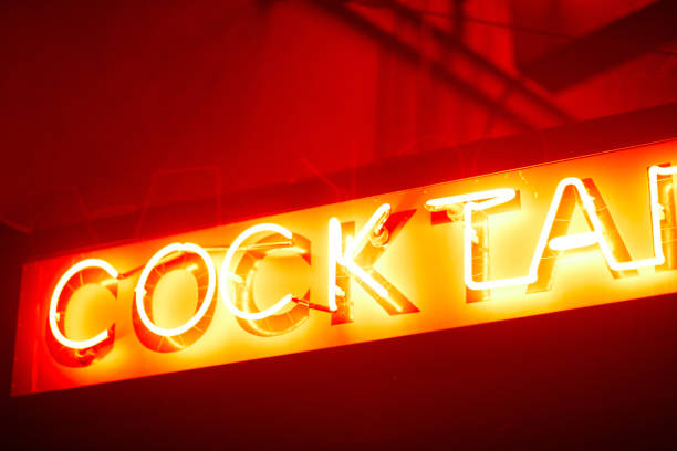 a neon sine at night outside a bar in Encinitas California reads \