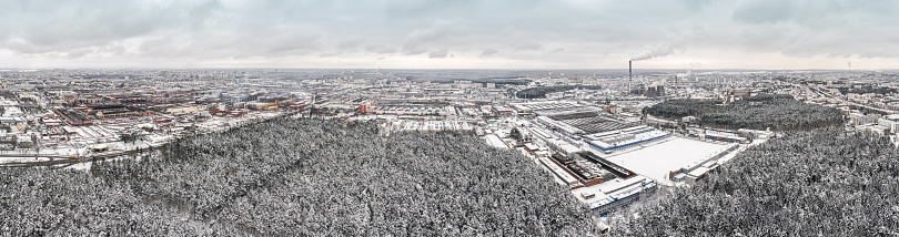 panoramic aerial view of urban industrial district with factory buildings, warehouses and thermal power plant with smokestacks. Minsk, Belarus.