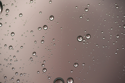 A photo of water droplets from rain on a glass window