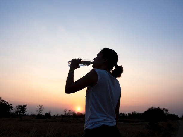 istock Asian woman drinking water after exercise. 1299704782