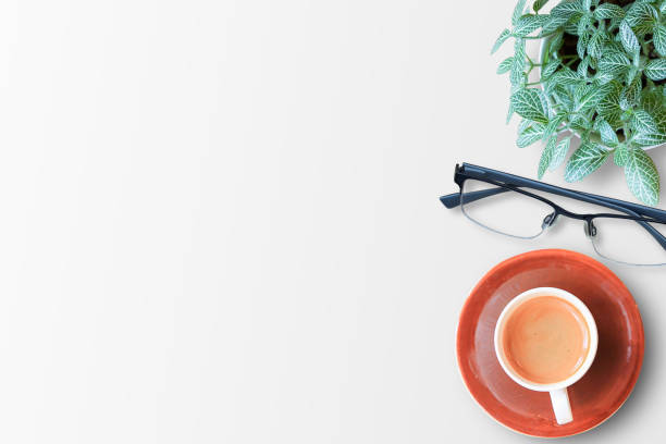 istock Top view coffee cup and glasses on white table background 1299708061