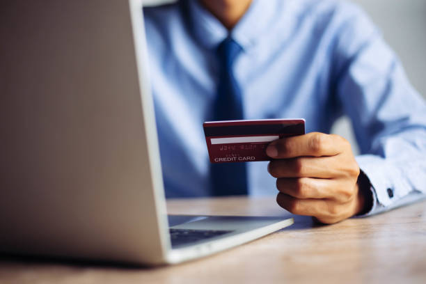 istock Online payment hands holding credit card and using laptop. Online shopping concept. 1299708877