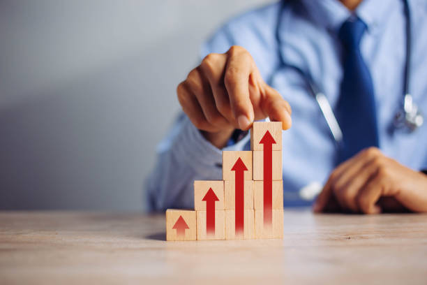 istock businessman hand  arranging wood block stacking as step stair with arrow up.concept for business growth success process. 1299708893