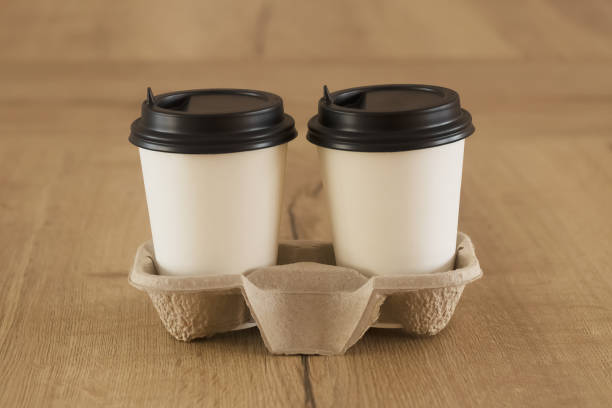 istock Coffee to go. Two white paper cups with a blank space for the logo. 1299711041