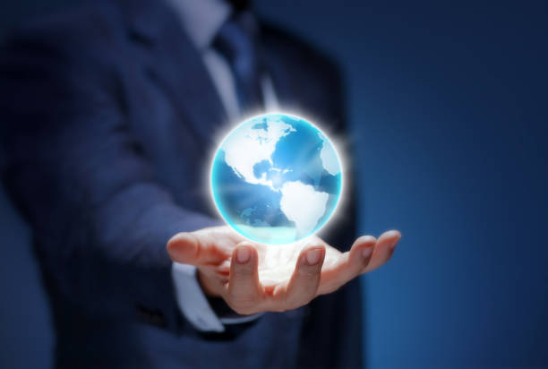 istock Man show USA world map for communicate, connection, technology, worldwide, network, internet concept. Global business world in hand. Businessman wear suit holding the planet earth on blue background. 1299711742