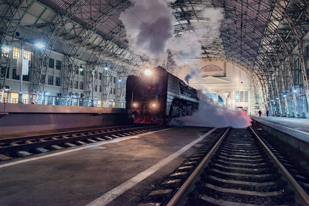 Moscow, Russia - January 30, 2021: Retro steam train departs from the passenger platform.
